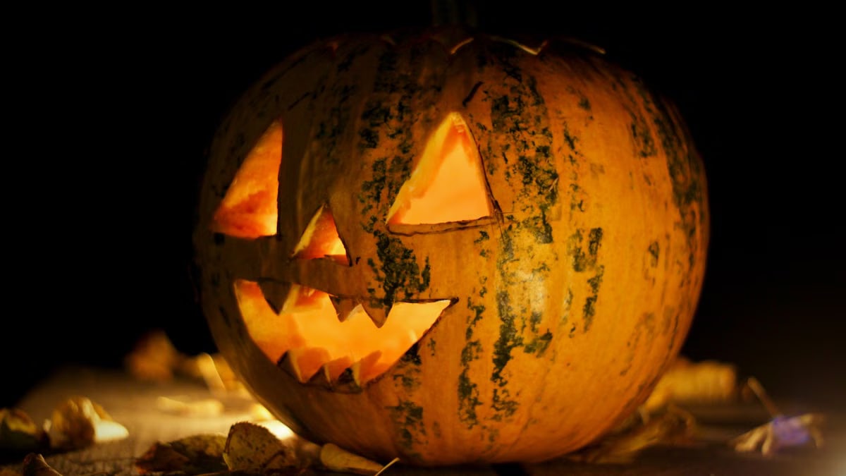 A carved and illuminated pumpkin Jack-o'-lantern creating a spooky Halloween atmosphere in Hungary.